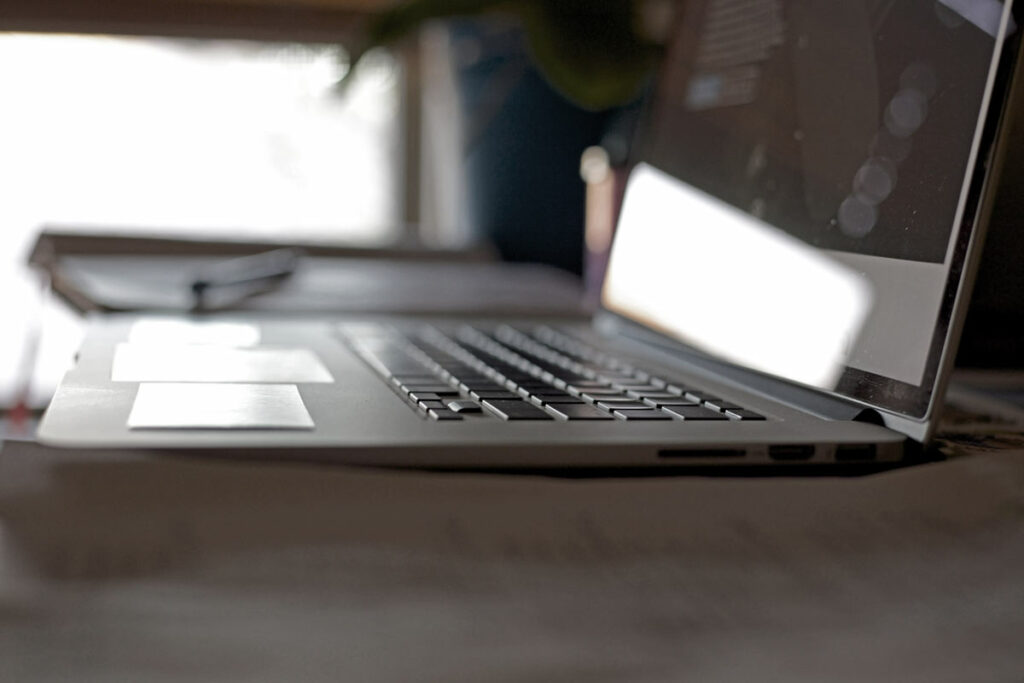 mac book pro sitting on desk by open window at memphis tennessee office place original photographer images by prefocus signifying shutdown for content about maximizing blog posts jordan trask