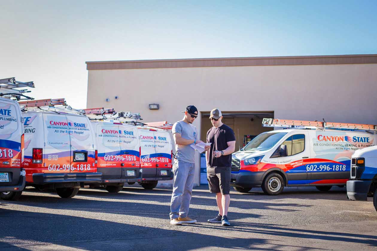 jordan-trask-from-prefocus-solutions-discussing-brand-development-services-with-partner-nathan-seeley-of-bluesoft-websites-during-corporate-photoshoot-for-phoenix-local-hvac-company-in-sun-city-west
