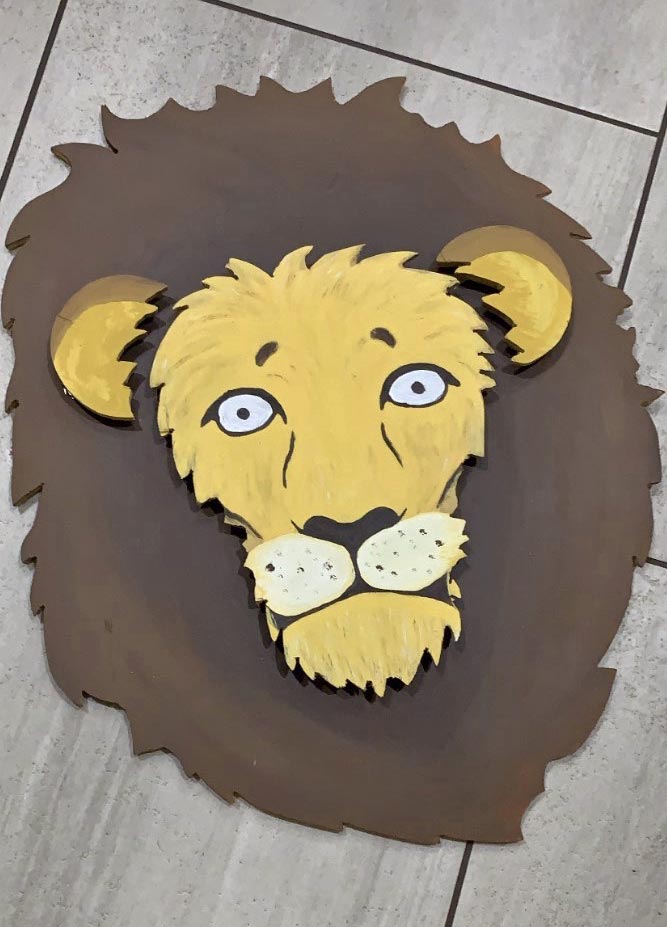 overhead photo of lion themed artwork design by jordan trask for kids room wood work jig saw and acrylic paints with minor shading details for home display memphis tennessee services