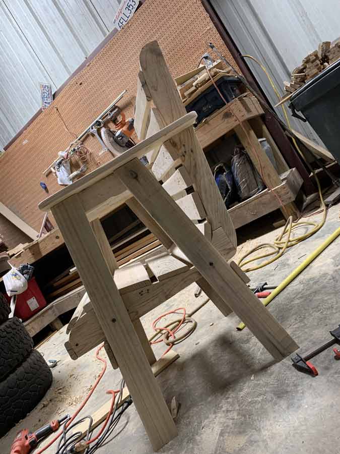 angled look at custom woodworker chair in olive branch mississippi with joint of back and seat uniquely made to ensure heavy person doesn't break it jordan trask