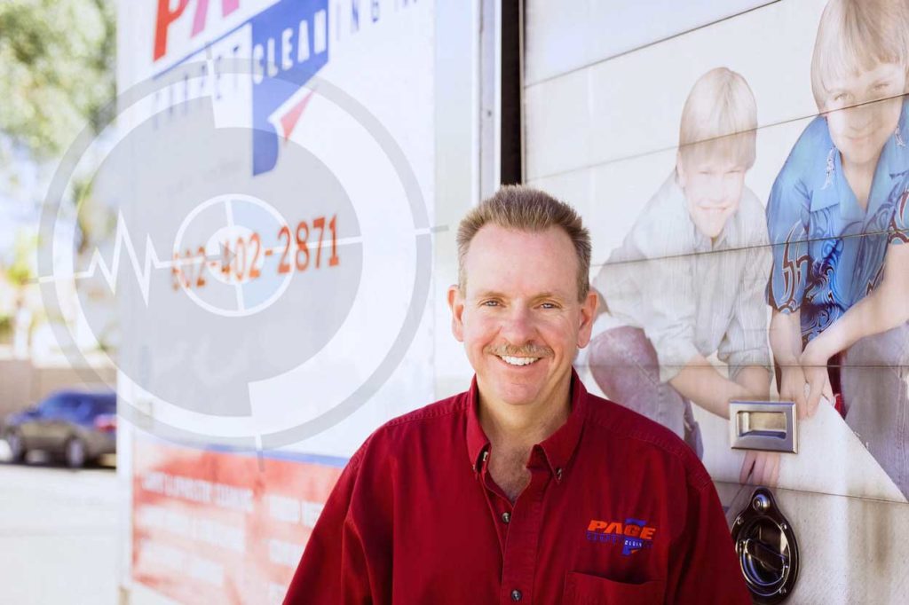 carpet cleaning professional company owner standing in front of branded work van outside residential location with videographer for authentic interview on the job now serving memphis tennessee