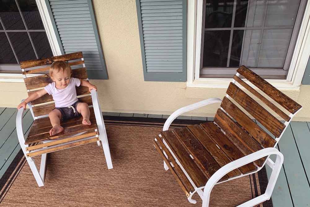 hand crafted wood slat seating for patio furniture chairs with custom rocker and arm rests wood worker's son relaxing in olive branch mississippi