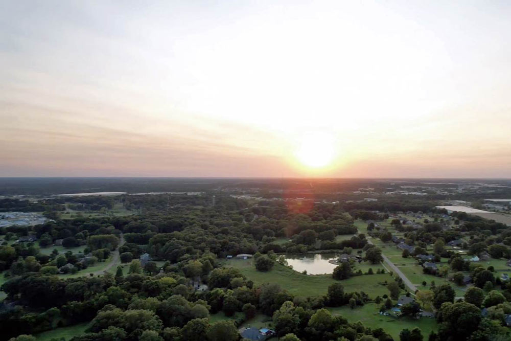 curving road heading away from memphis into central tennessee by drone videographer in olive branch for traveling website high quality overhead views