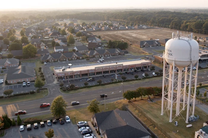 full shot of business complex from the sky drone aerial photographer jordan trask by southaven family block with residential neighborhoods in distance before horizon setting sun memphis creative director