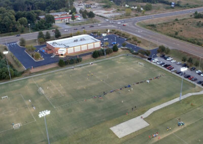 looking down on sports complex open fields lined for soccer night games outside facility lights on park olive branch mississippi drone photographer