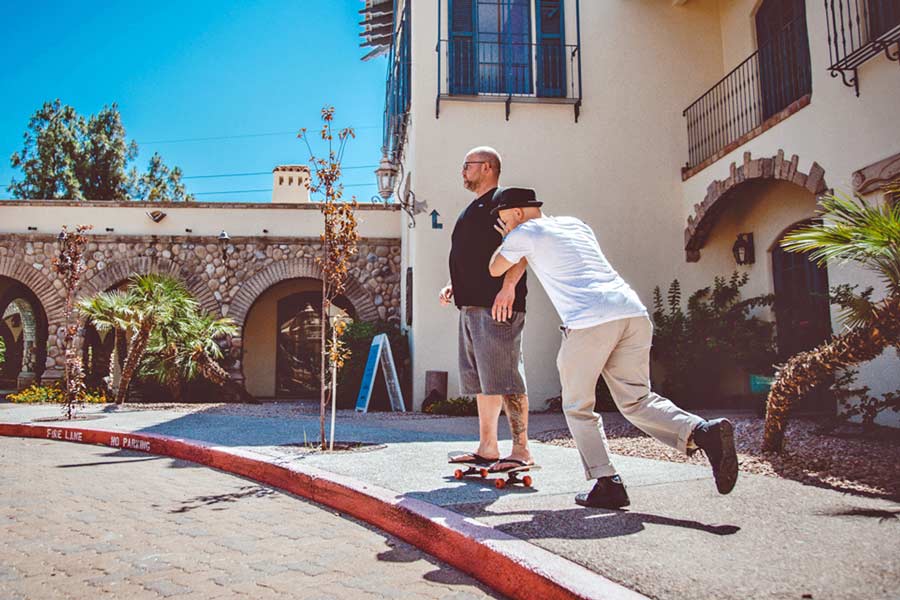 creative director near memphis pushing client on skateboard to emulate how video scene will transpire for intro to podcast prefocus solutions serves