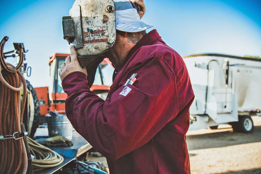 authentic image of welding professional gearing up for service near memphis tennessee to promote quality clothing line for blue collar workers brand strategy jordan trask prefocus solutions custom trucks