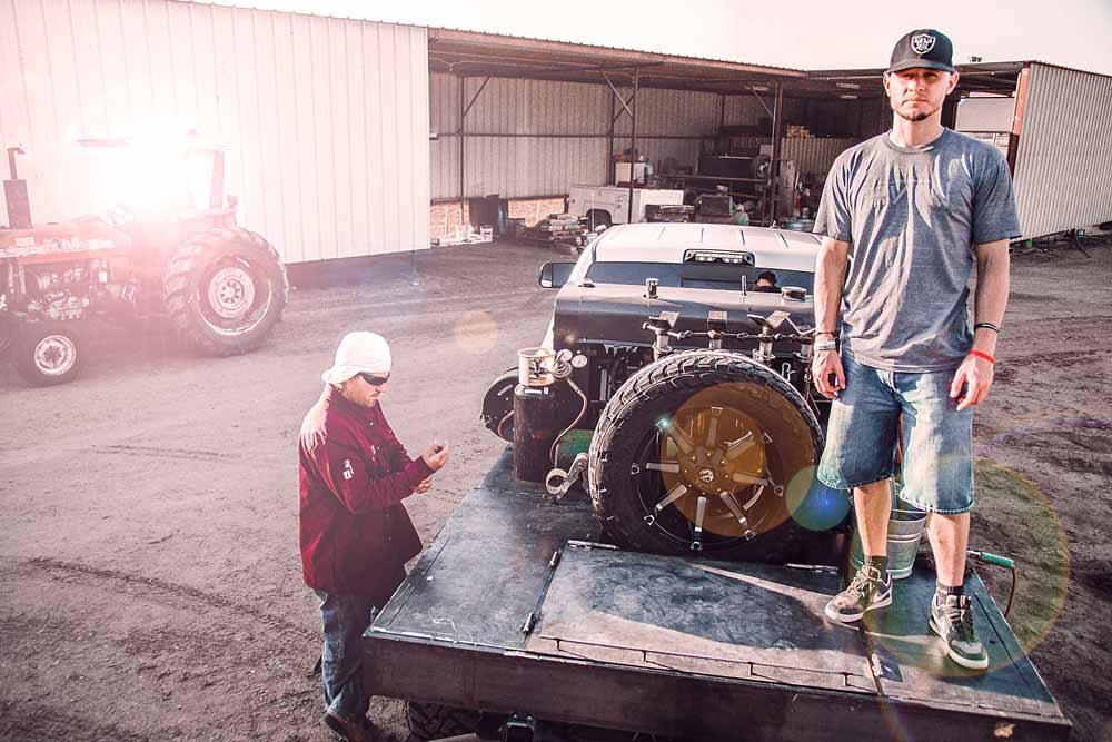 standing on the back of a welding truck in ball cap with client preparing vehicle for branded photo session near memphis tennessee portfolio work