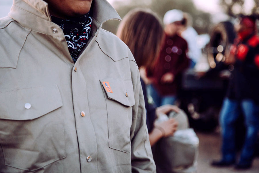 original shot of blue collar worker getting done for the day in american branded attire with hankerchief for website imagery strategy for ecommerce platform creative directior khaki sunset near memphis tn