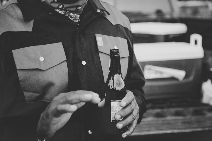 black and white portrait of quality work shirt apparel branding strategy beer in hand talking at end of work day with cooler of beer in back of truck creative director JT from prefocus solutons