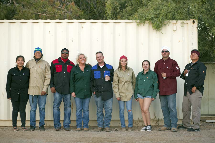 team photo western wear work shirts american made branding about us page creative writer and media strategist jt of prefous solutions in front of storage container wearing marketed product for authentic session near memphis tennessee