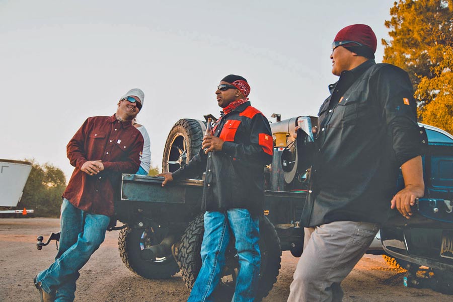 group of guys hanging out around work site after job is complete having a beer in team work shirts for autumn weather showcasing brotherhood during authentic moment captured by creative director jordan trask of prefocus solutions in memphis tennessee