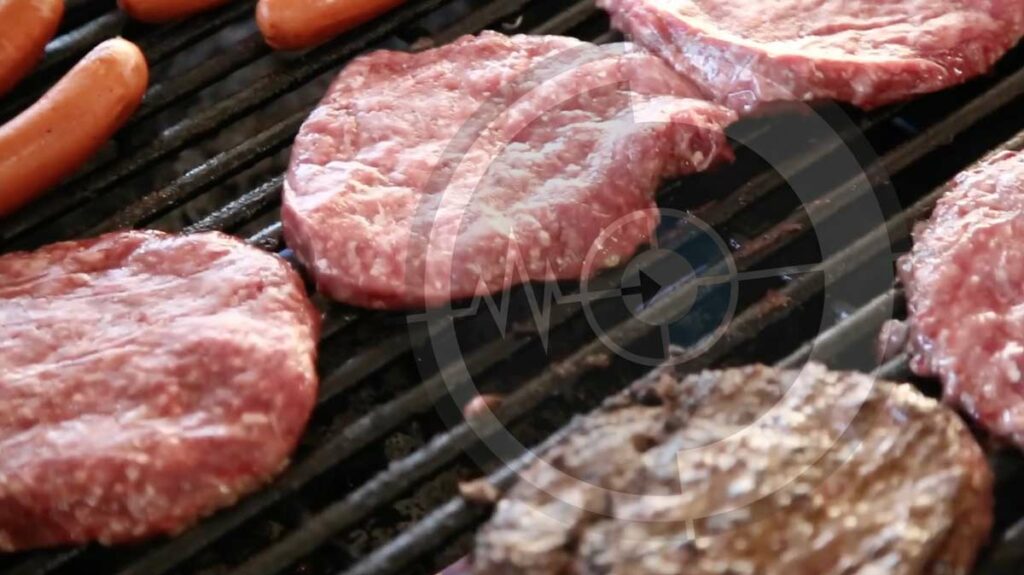 close up b roll videography of grill with bison meat for local farm near desoto county mississippi by prefocus production services some of meat is flipped with hotdogs to the side