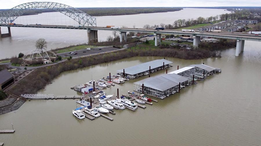 awesome drone portrait of memphis yacht club near mississippi river museum and boat dock with hernando desoto bridge in background high altitude cloudy skyline prefocus video services desoto county ms