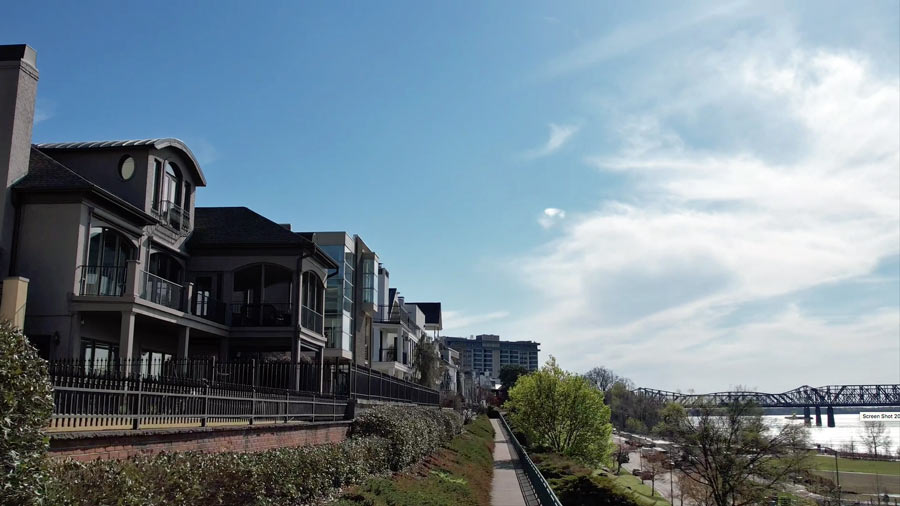 original photography from memphis river walks park and recreational development projects and urban housing alongside mississippi banks with memphis-arkansas bridge and other downtown buildings in the background by prefocus aerial media services