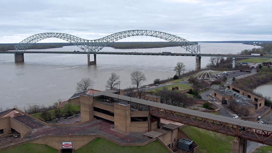 hernando desoto interstate bridge in background of drone photo of mississippi river museum at the end of pedestrian catwalk over wolf river harbor next to boat ramp and wide open mississippi waters by drone pilot olive branch ms prefocus solutions